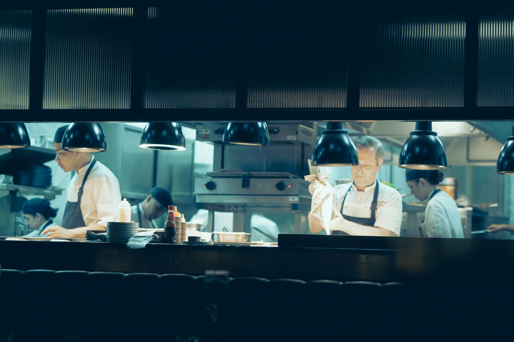 Chefs preparing dinner in an open kitchen